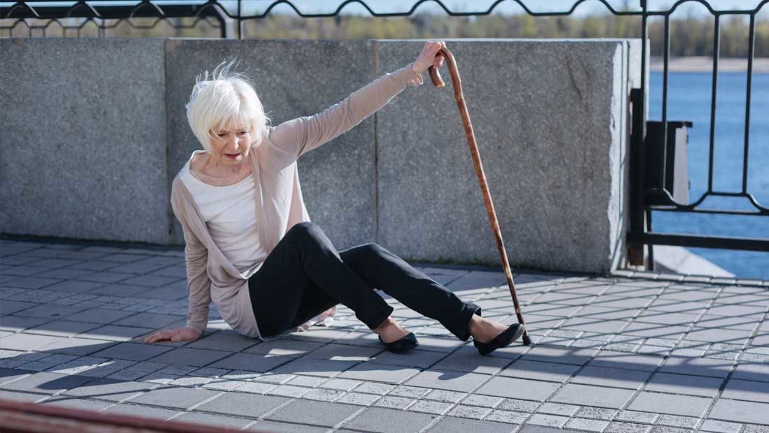 Elderly woman falling over