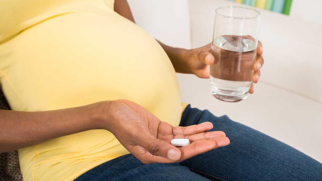 Pregnant woman taking pills
