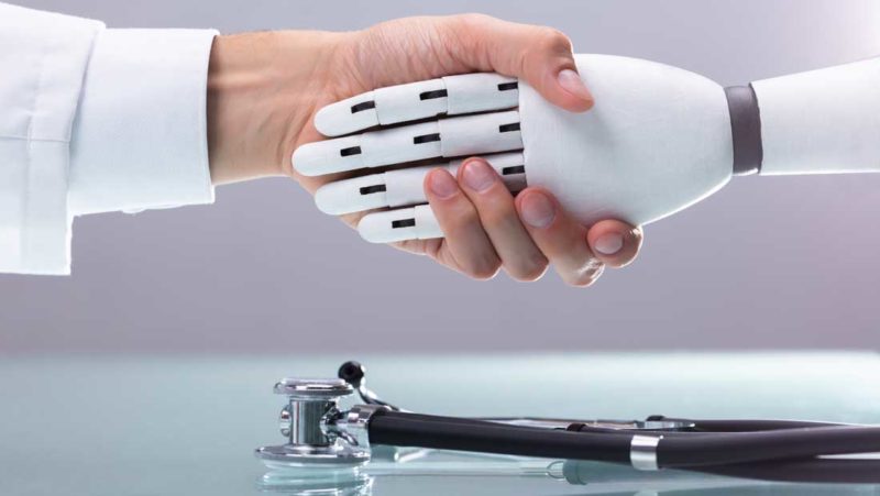 robot hand held by a doctor