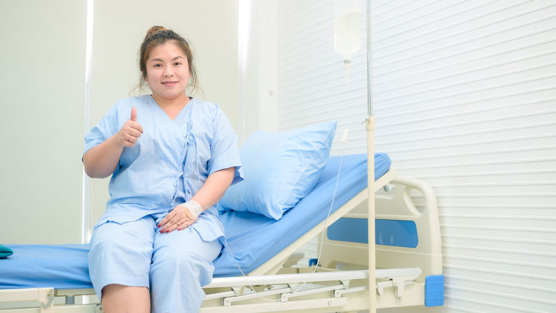 Young patient sitting on a hospital bed