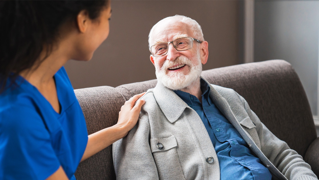 Elderly male patient talking to a pharmacist