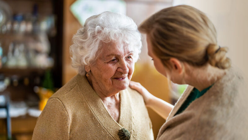 Pharmacist consulting with an elderly female patient